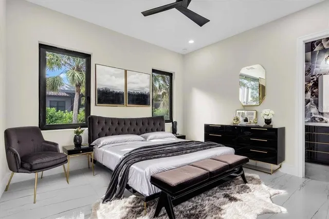 a bedroom with a bed a dresser next to a window