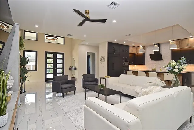 a living room with furniture and a potted plant