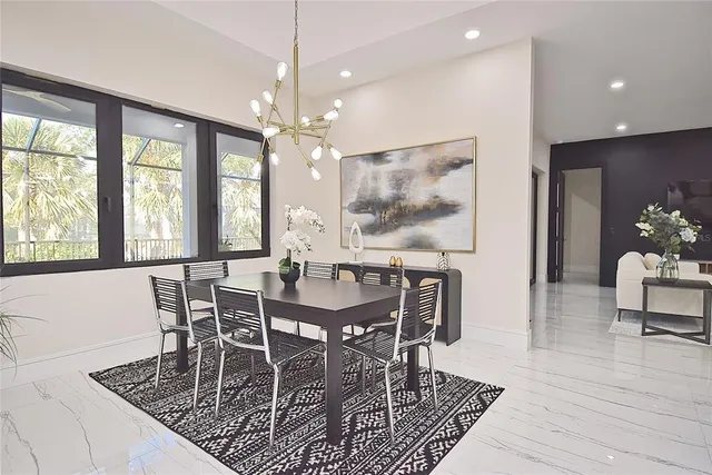 a living room with furniture a chandelier and a window