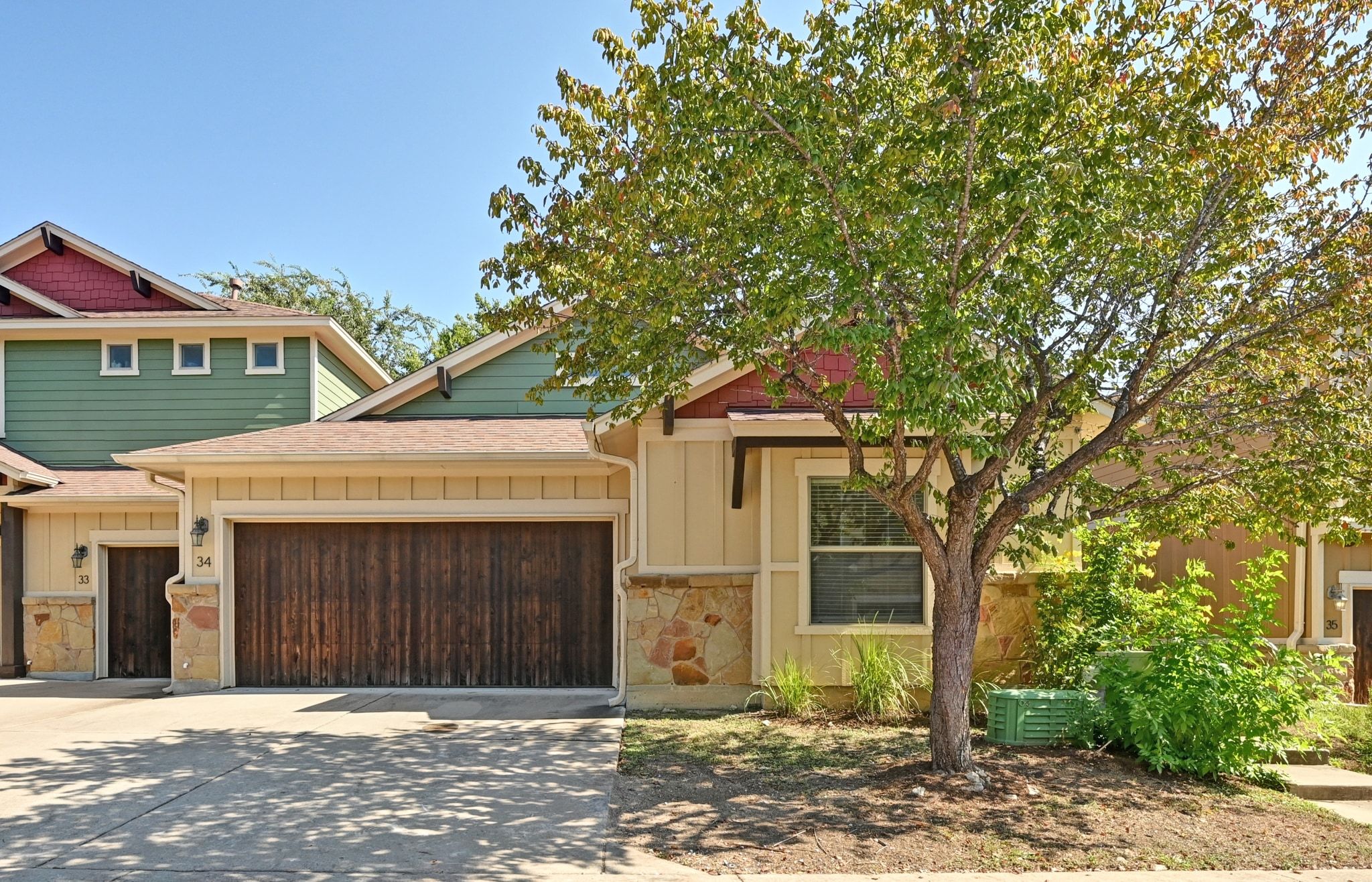 6708 Menchaca Road, Unit 34 Austin, TX 78745 - Photo 1 of 1 Craftsman inspired home with stone siding, board and batten siding, driveway, and an attached garage