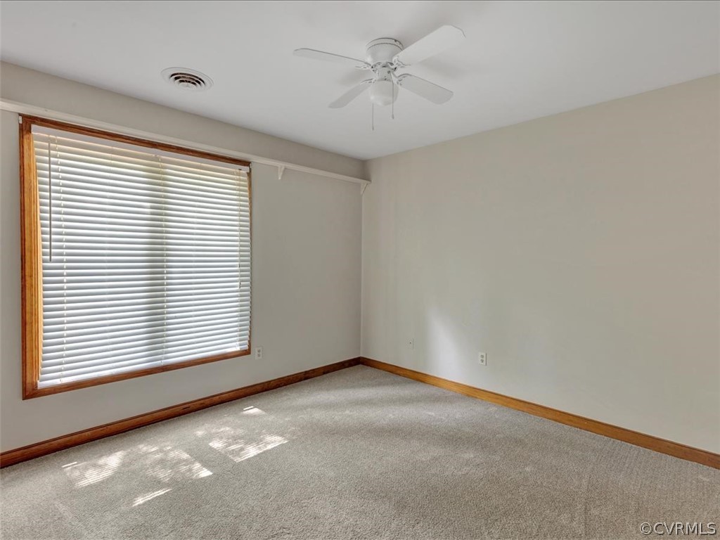 13800 Sterlings Bridge Road Midlothian, VA 23112 - Photo 19 of 31 an empty room with a window and a ceiling fan