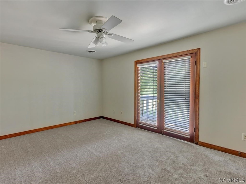 13800 Sterlings Bridge Road Midlothian, VA 23112 - Photo 23 of 31 an empty room with chandelier fan and windows