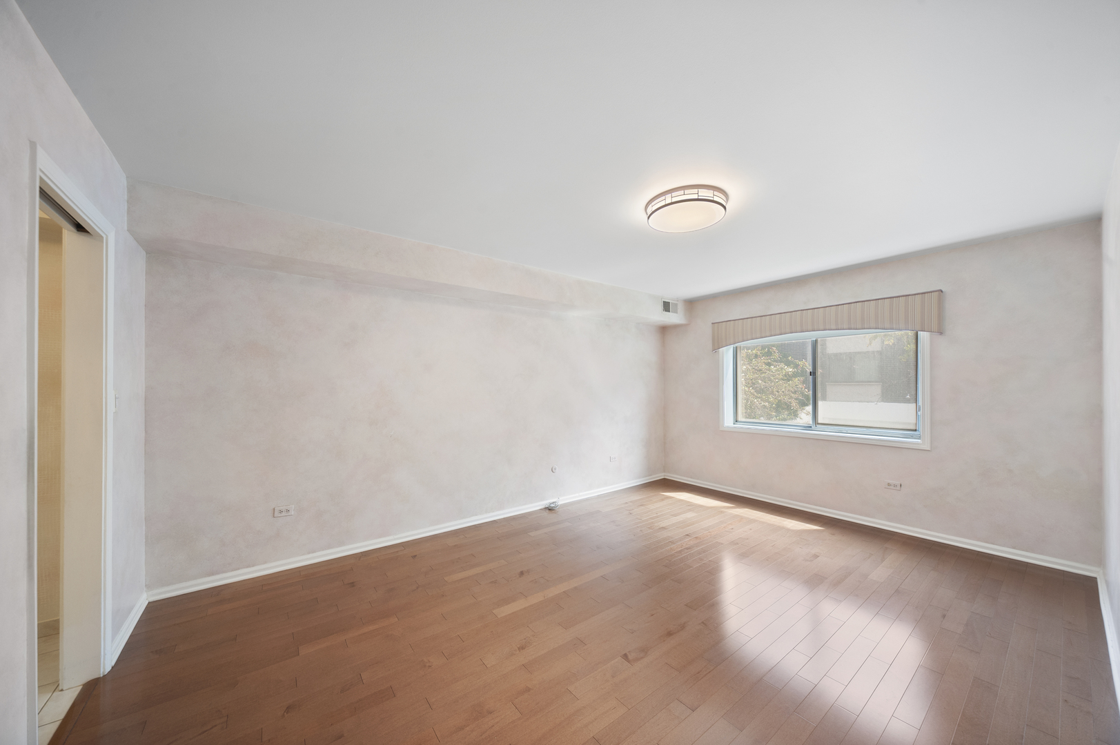 4949 Golf Road, Unit 101 Skokie, IL 60077 - Photo 12 of 22 a view of an empty room with a window