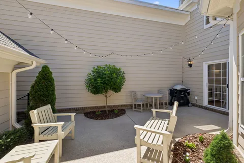 a front view of a house with outdoor seating