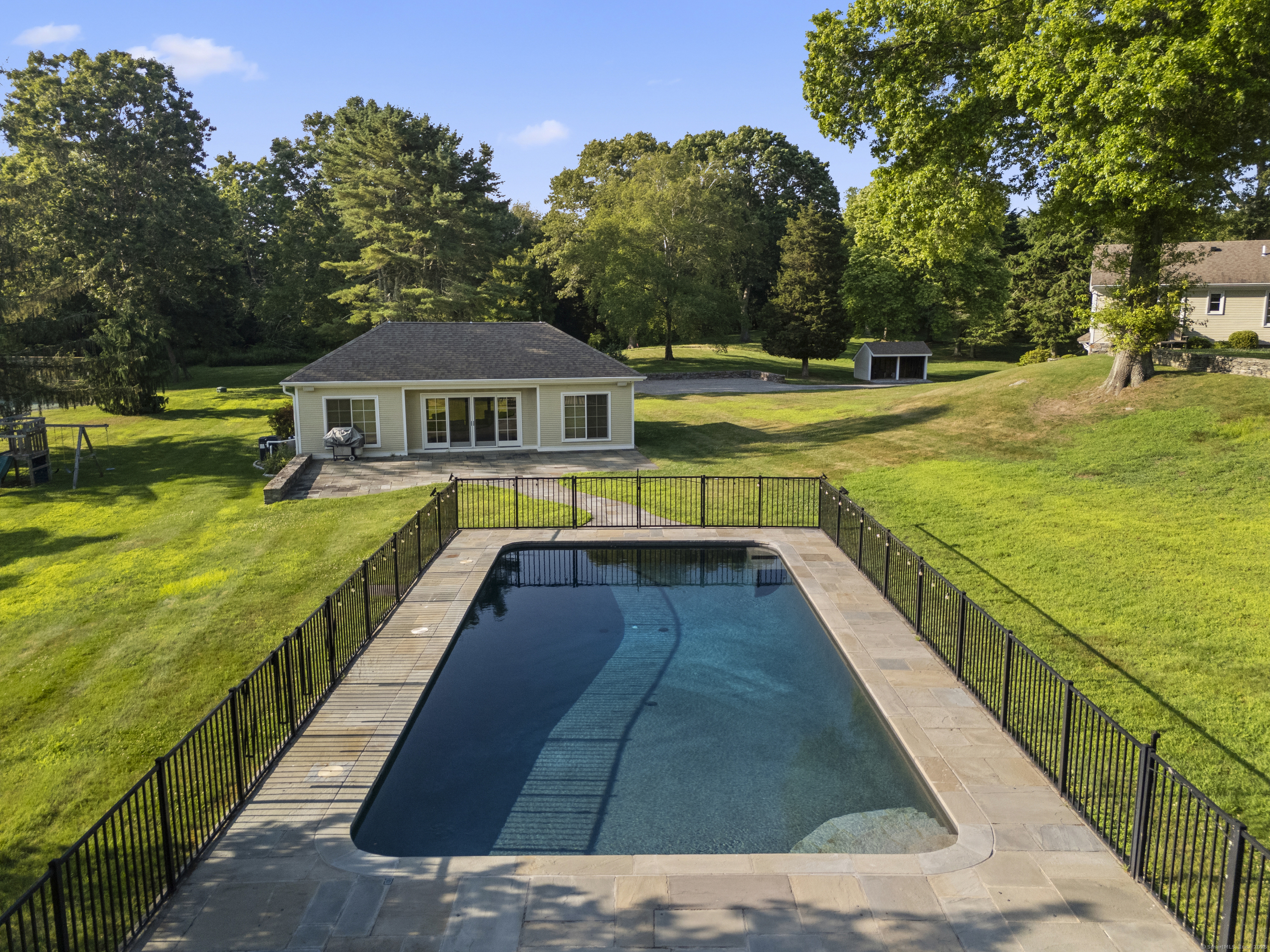 455 Stonington Road Stonington, CT 06378 - Photo 4 of 39 a view of an ocean with swimming pool and trees in the background