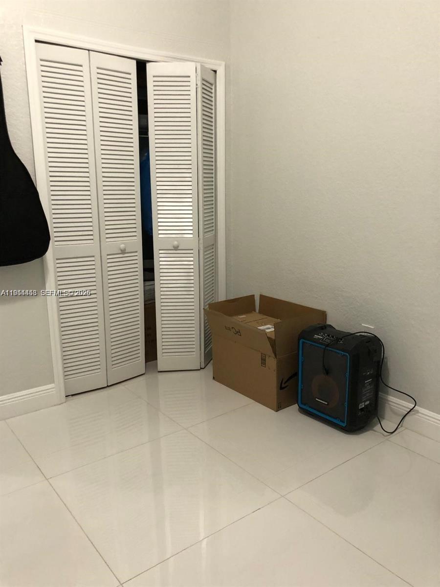 27 Northeast 13th Street, Unit 4 Homestead, FL 33030 - Photo 6 of 8 a view of an empty room with wooden floor