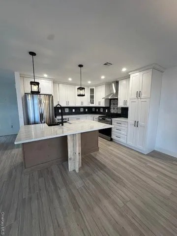 a large kitchen with lots of counter space and stainless steel appliances