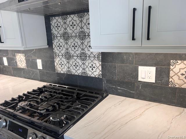 74 Beach Road Stony Point, NY 10980 - Photo 14 of 38 a close view of a stove a microwave and cabinets in the kitchen