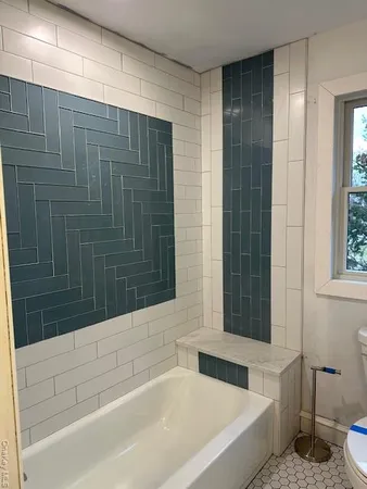 a bathroom with a bathtub and a shower