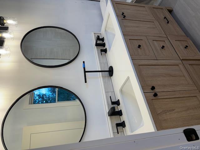 74 Beach Road Stony Point, NY 10980 - Photo 29 of 38 a bathroom with a double vanity sink and a mirror