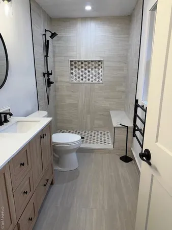 a bathroom with a toilet sink and a mirror