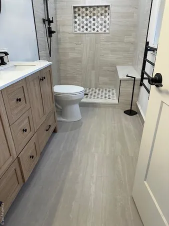 a bathroom with a sink a toilet and shower