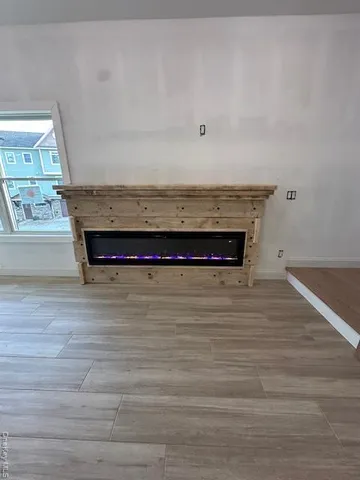 a view of a room with wooden floor and cabinet