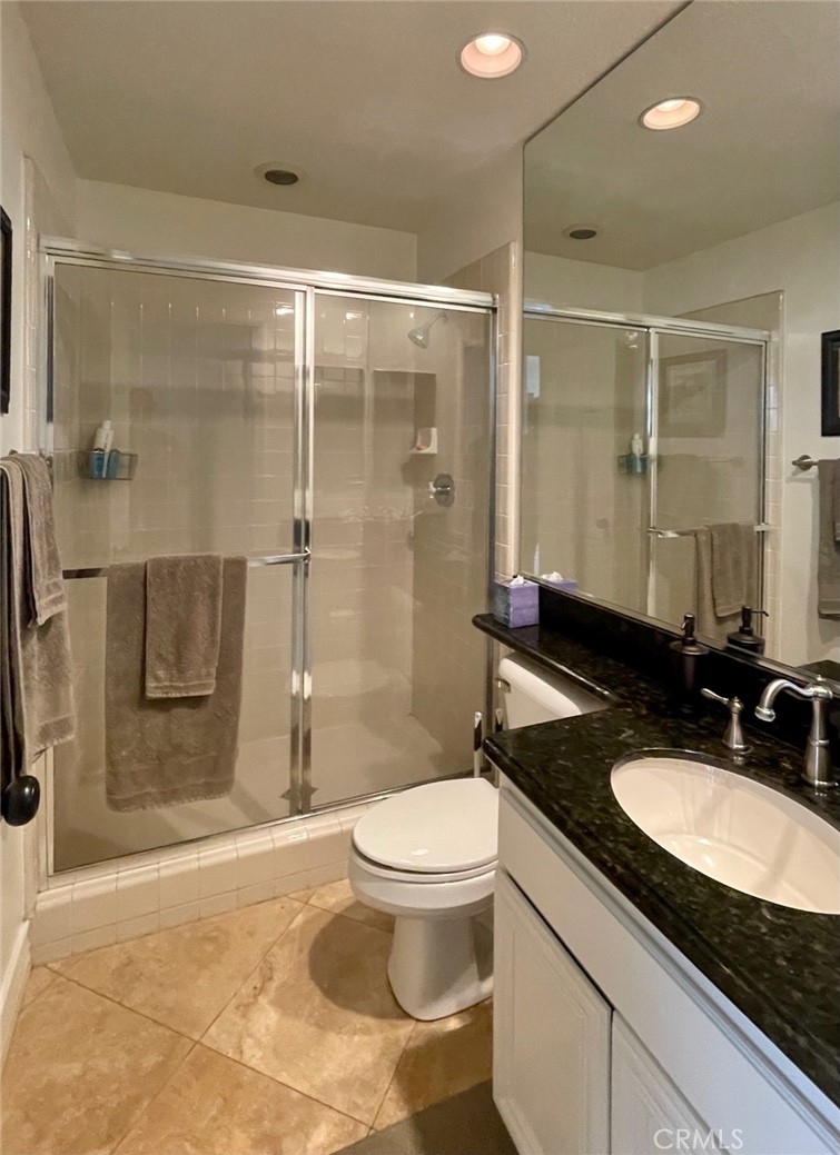 808 Carnaros San Clemente, CA 92672 - Photo 11 of 16 a bathroom with a granite countertop sink a toilet a mirror and shower