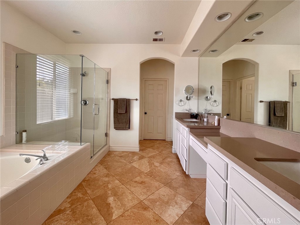 808 Carnaros San Clemente, CA 92672 - Photo 6 of 16 a large bathroom with a granite countertop tub a double vanity sink and a large mirror