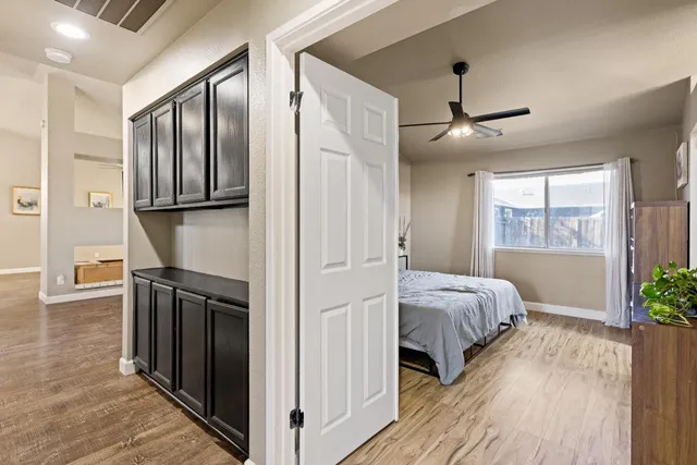 a view of a bedroom with wooden floor and balcony