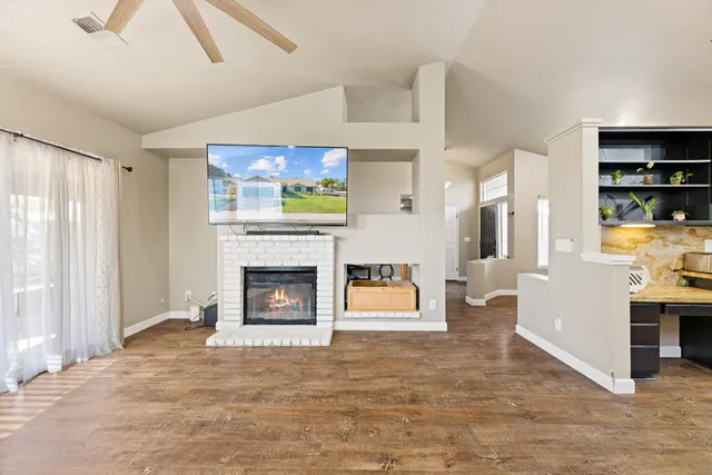 a view of a livingroom with a fireplace and window
