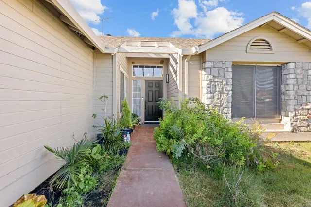 a front view of a house with garden
