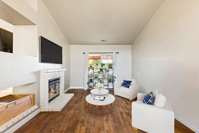 a living room with fireplace furniture and a flat screen tv