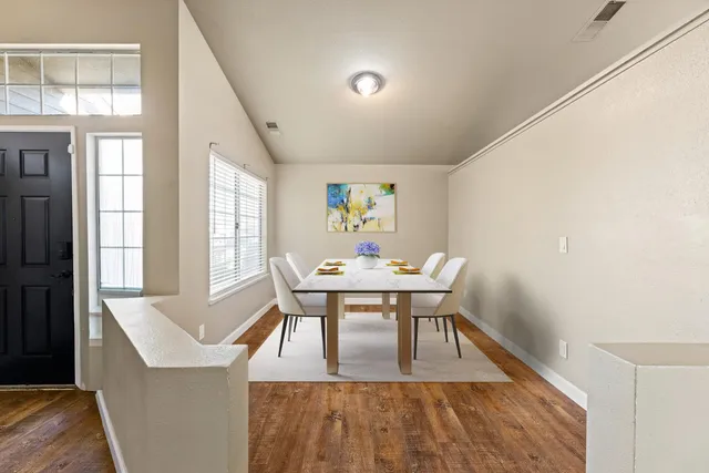 a view of a dining room with furniture and window