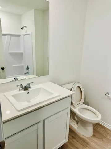 a bathroom with a sink toilet and mirror