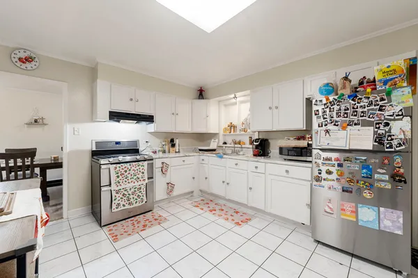 a kitchen with stainless steel appliances granite countertop a refrigerator sink and cabinets