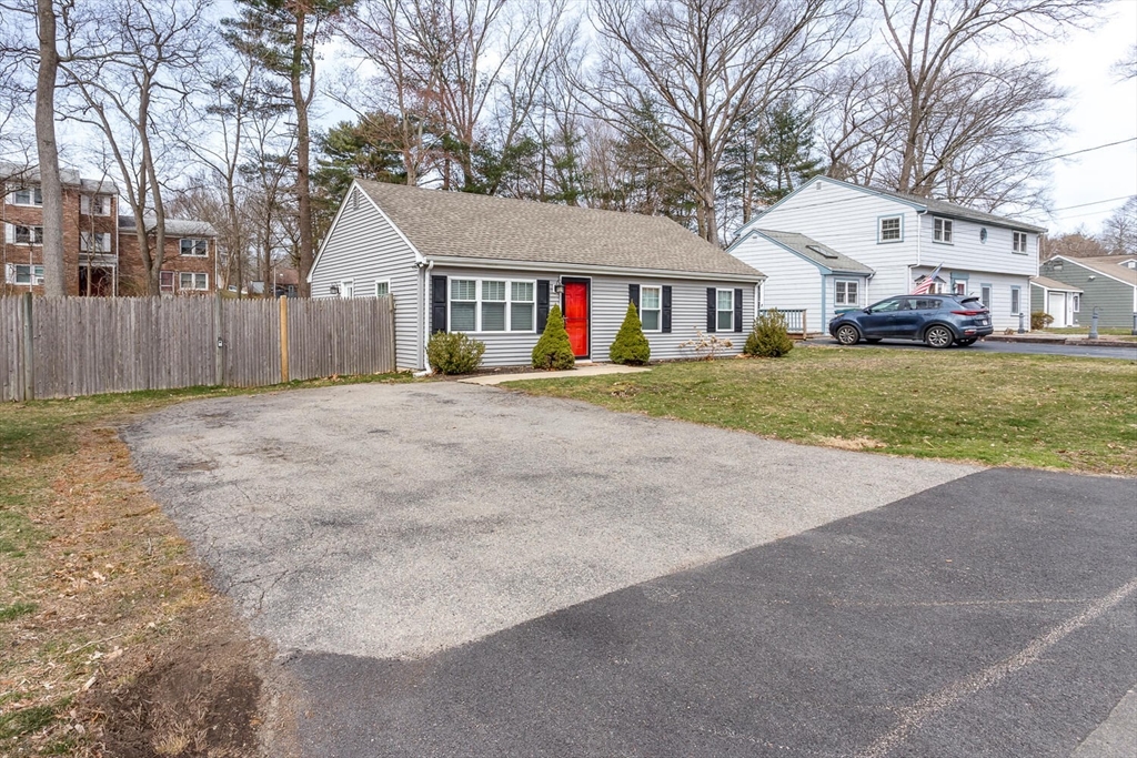 71 Highland Street Canton, MA 02021 - Photo 3 of 12 a view of a big house with a big yard and large trees