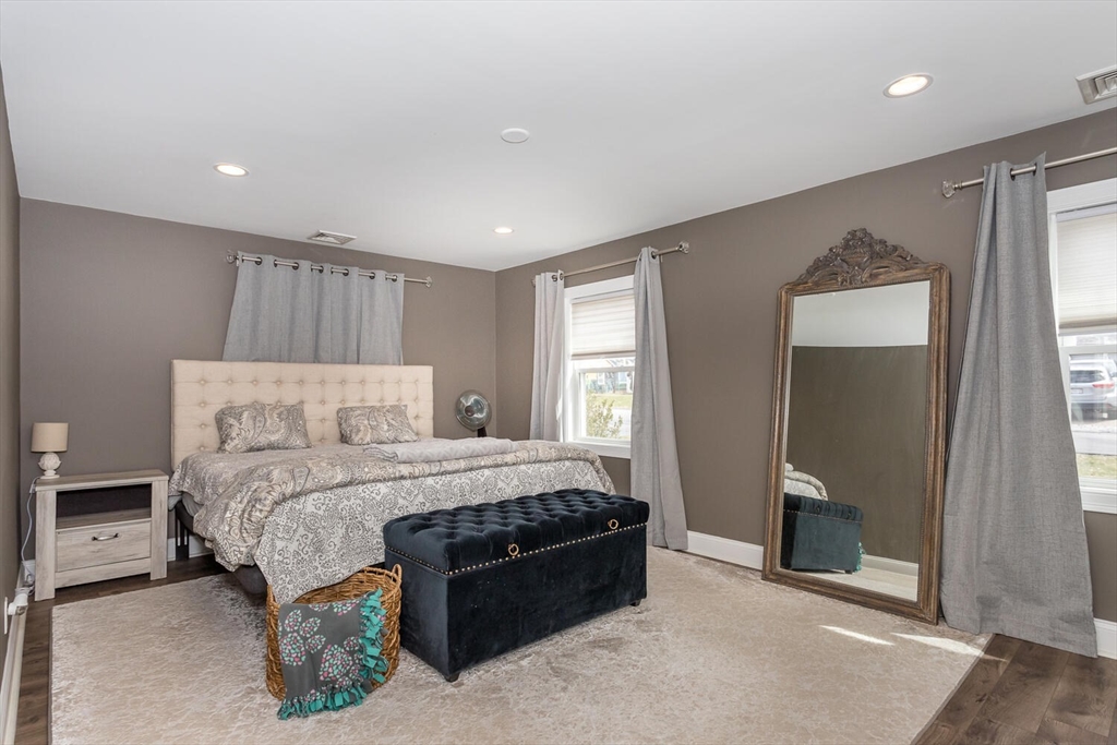 71 Highland Street Canton, MA 02021 - Photo 7 of 12 a bedroom with a bed and a mirror
