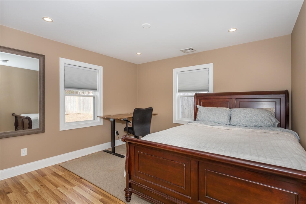 71 Highland Street Canton, MA 02021 - Photo 8 of 12 a bedroom with a bed and a table in it