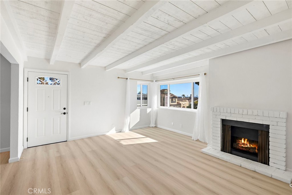 33771 Copper Lantern Street Dana Point, CA 92629 - Photo 2 of 16 a view of empty room with wooden floor and fireplace