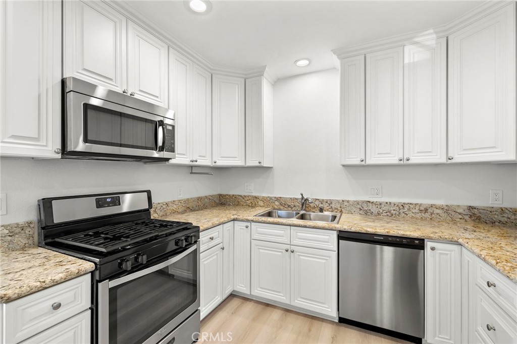 33771 Copper Lantern Street Dana Point, CA 92629 - Photo 7 of 16 a kitchen with granite countertop white cabinets and stainless steel appliances