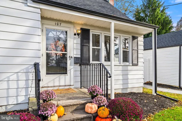 a view of a porch with a table and chairs and floor to ceiling window