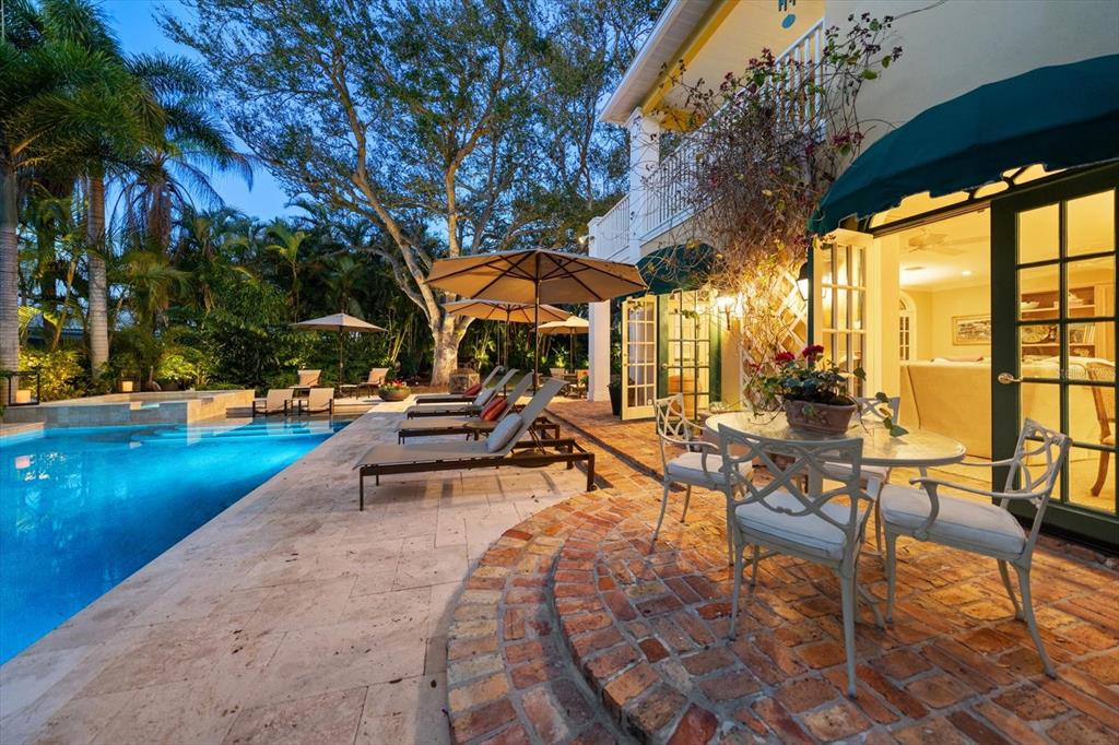 100 Sarasota Road Belleair, FL 33756 - Photo 46 of 75 a view of a swimming pool with lounge chairs in patio