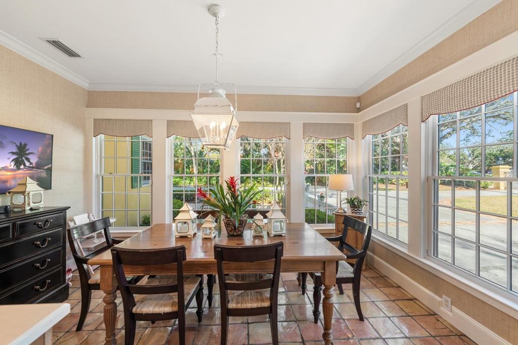 100 Sarasota Road Belleair, FL 33756 - Photo 8 of 75 a view of a dining room with furniture large windows and wooden floor