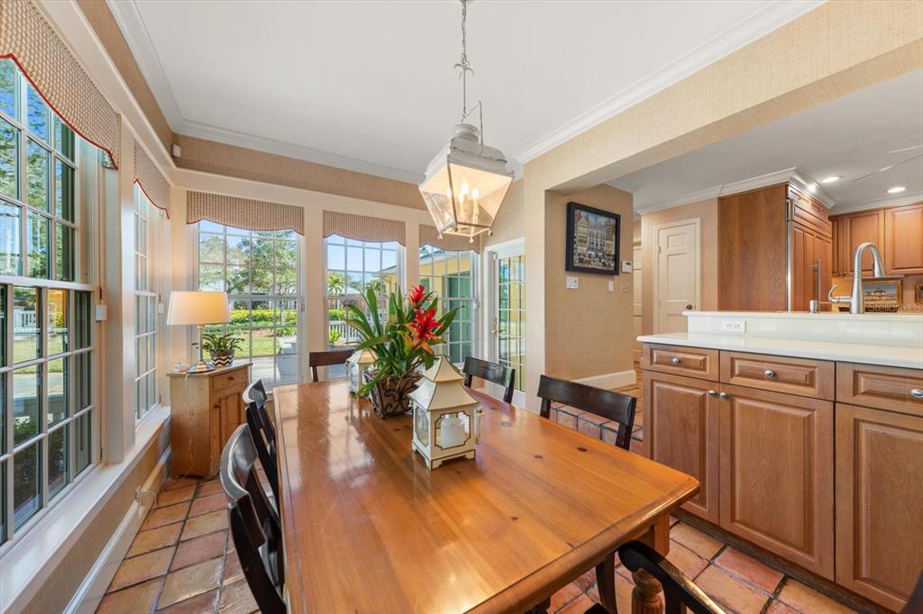100 Sarasota Road Belleair, FL 33756 - Photo 9 of 75 a dining room filled chandelier and wooden floor