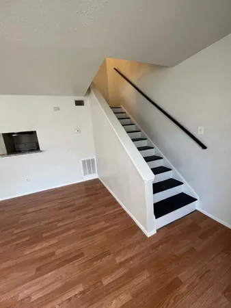 a view of entryway and hall with wooden floor