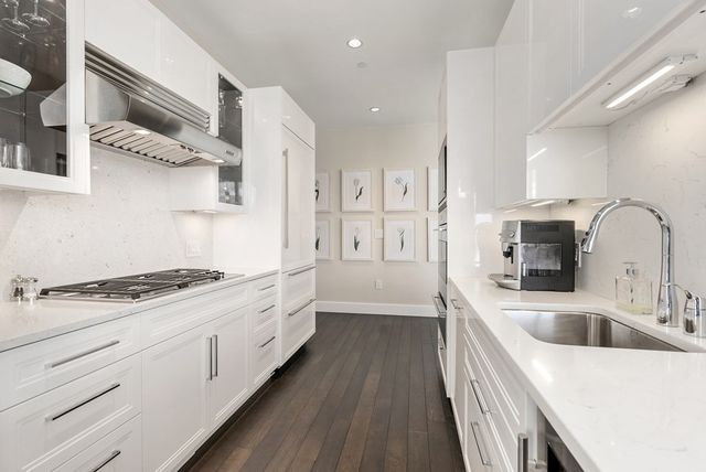 a kitchen with stainless steel appliances granite countertop a sink stove and refrigerator