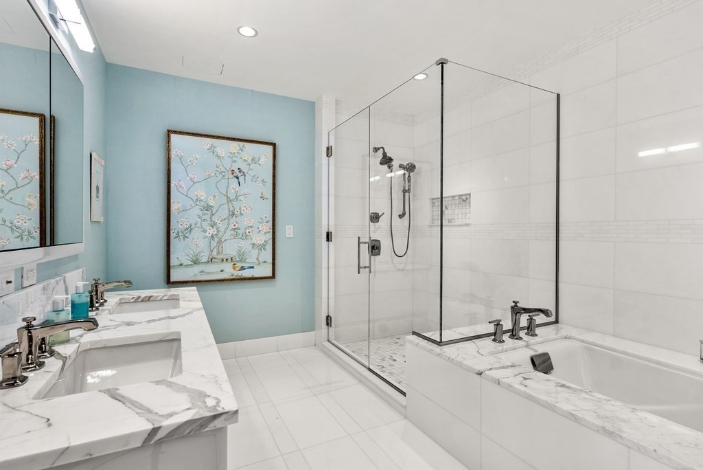 22 Liberty Drive, Unit 6A Boston, MA 02210 - Photo 18 of 42 a bathroom with a tub sink and mirror