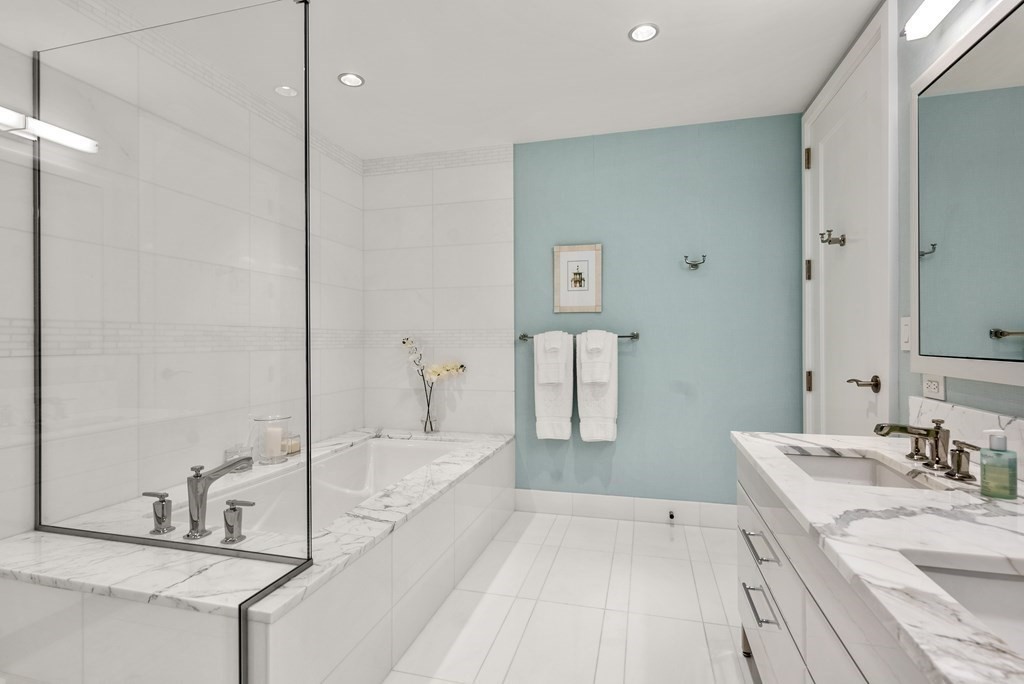 22 Liberty Drive, Unit 6A Boston, MA 02210 - Photo 19 of 42 a bathroom with a tub sink and a mirror