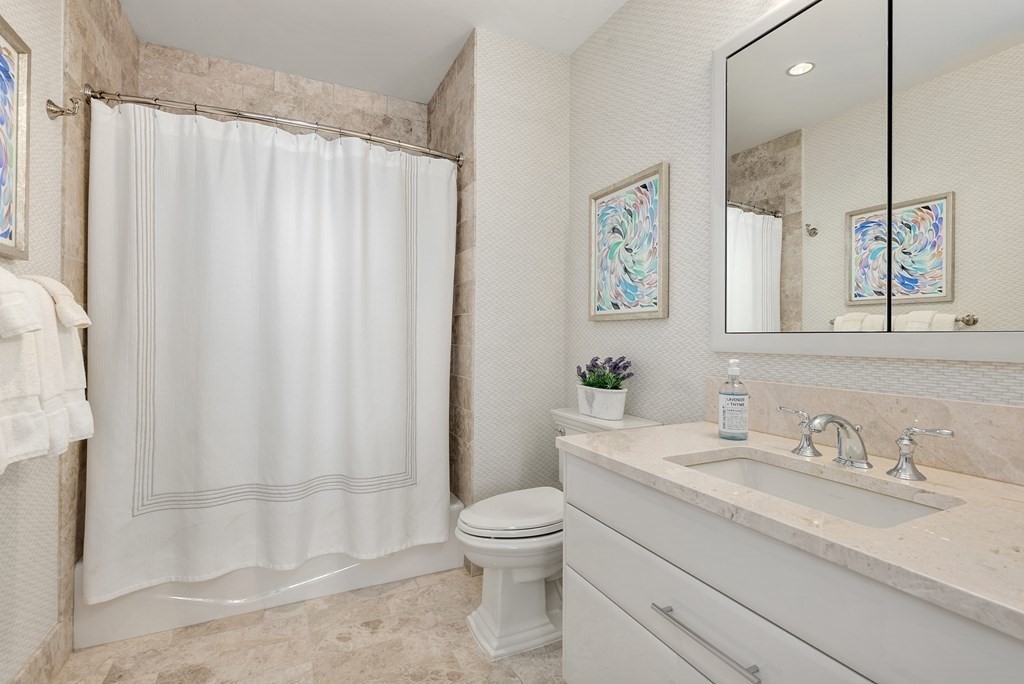 22 Liberty Drive, Unit 6A Boston, MA 02210 - Photo 22 of 42 a bathroom with a granite countertop sink a toilet and a shower