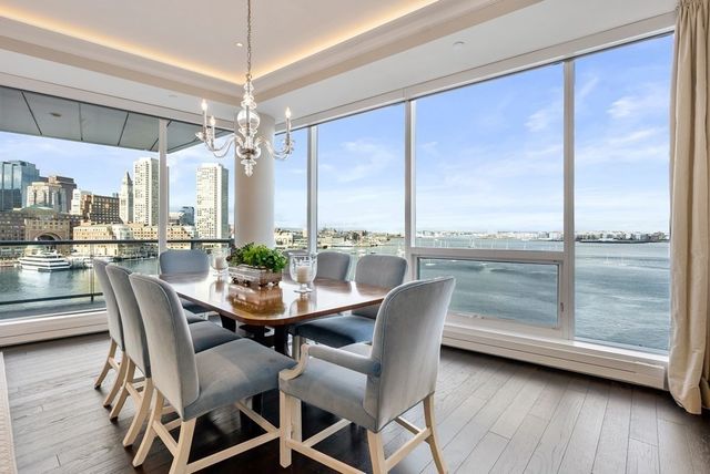 a dining room with furniture a chandelier and wooden floor