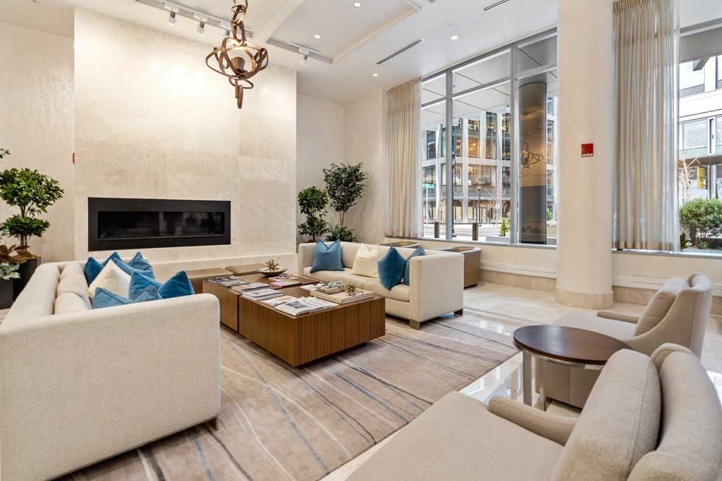 22 Liberty Drive, Unit 6A Boston, MA 02210 - Photo 37 of 42 a living room with furniture a chandelier and a flat screen tv