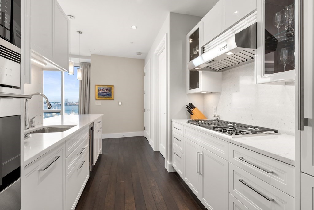 22 Liberty Drive, Unit 6A Boston, MA 02210 - Photo 9 of 42 a kitchen with stainless steel appliances granite countertop a stove and a sink