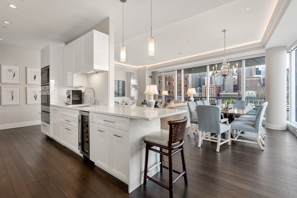 22 Liberty Drive, Unit 6A Boston, MA 02210 - Photo 10 of 42 a kitchen with a table chairs microwave and cabinets