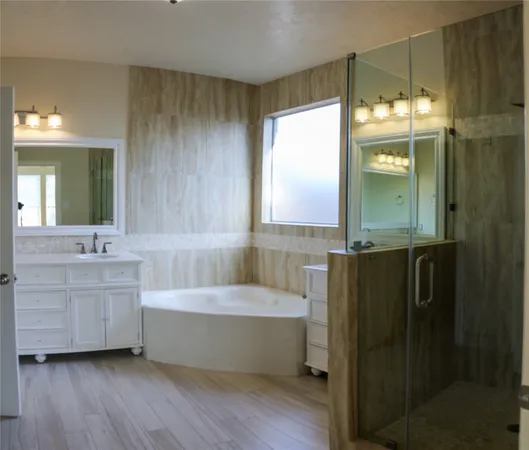 a bathroom with a tub sink and mirror