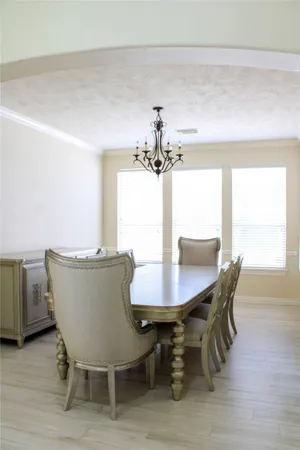 a dining room with furniture and window