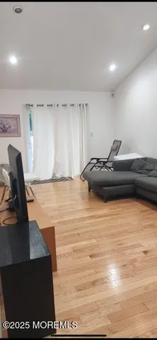 a upper view of whole floor with a black and white kitchen