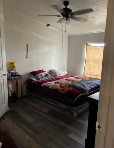 a view of a hallway with wooden floor and a door