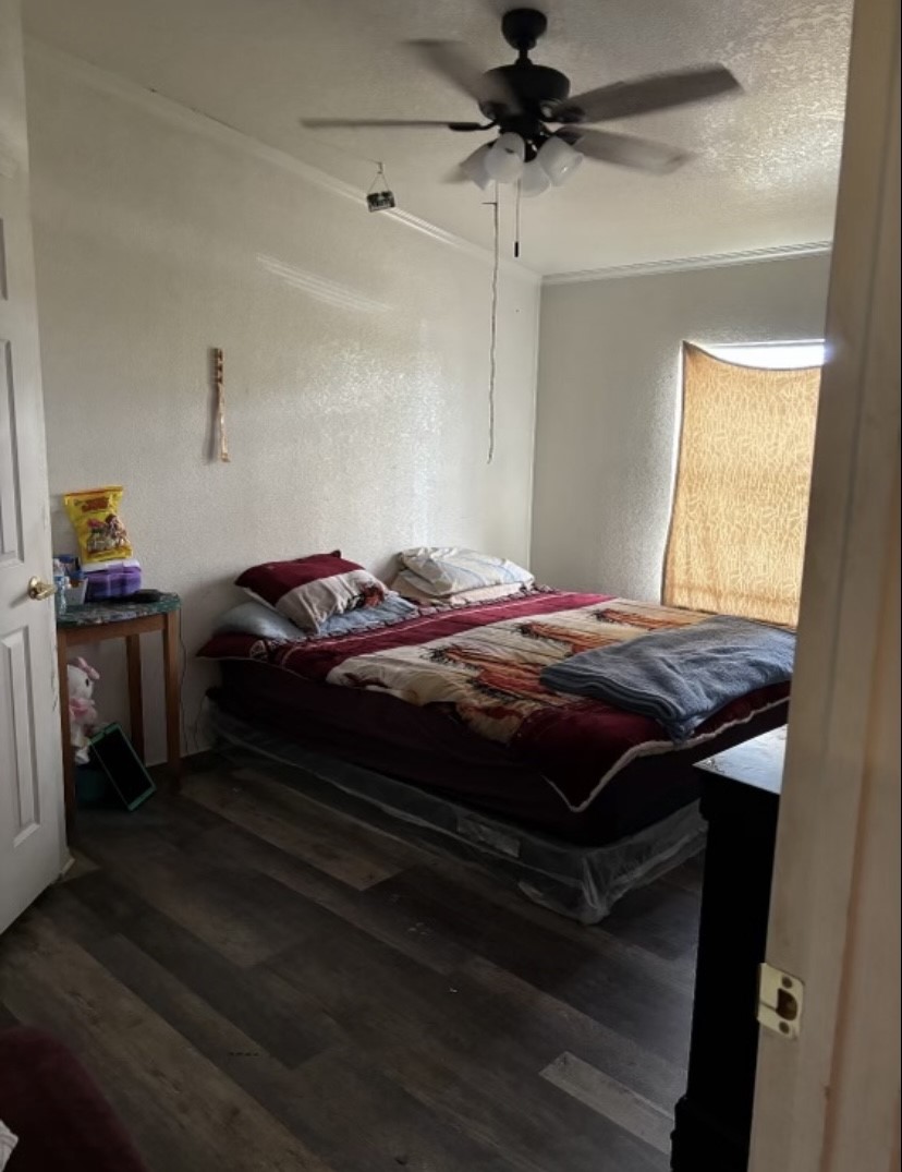 4021 Baker Road Needville, TX 77461 - Photo 12 of 14 a bedroom with a bed and a chandelier