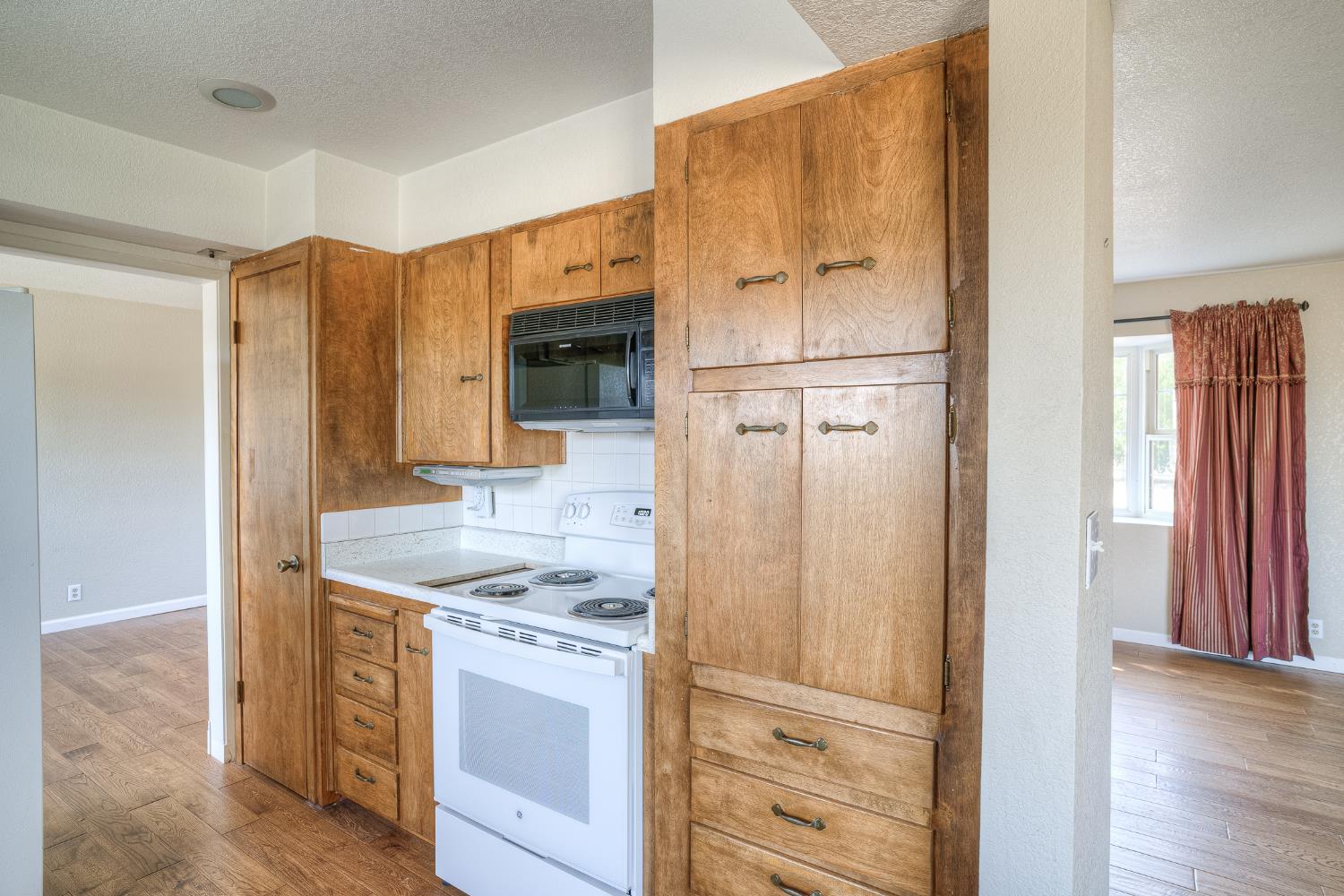 5463 Hankins Road Williams, CA 95987 - Photo 13 of 62 a kitchen with a refrigerator sink and cabinets